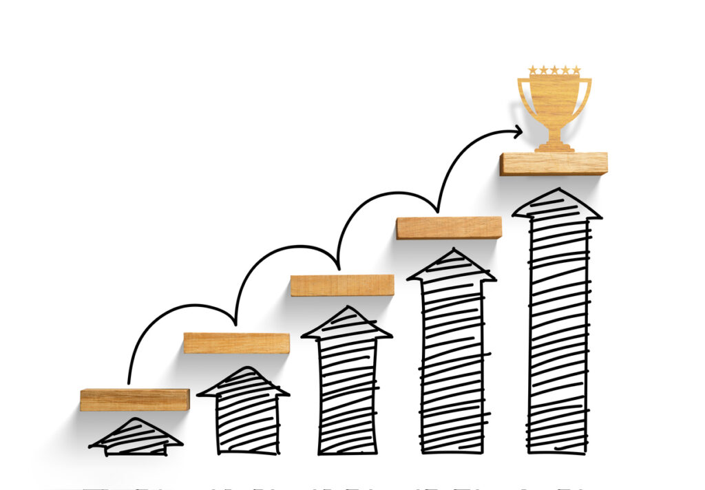 Wooden staircase to reach goal and win trophy with increase graph and arrow, successful