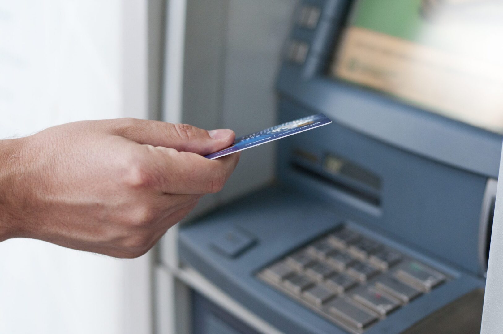 hand-inserting-atm-card-into-bank-machine-withdraw-money-businessman-men-hand-puts-credit-card-into-atm-scaled-1