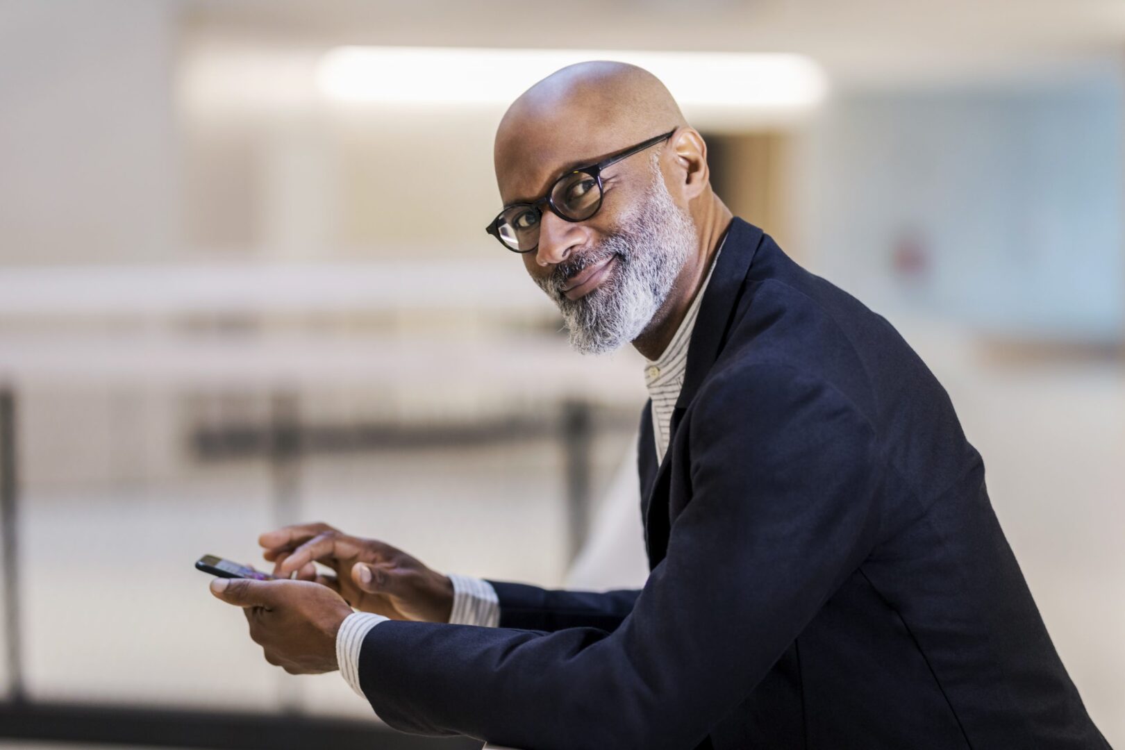 portrait-of-smiling-mature-businessman-with-cell-p-2022-03-08-01-20-14-utc-scaled-1