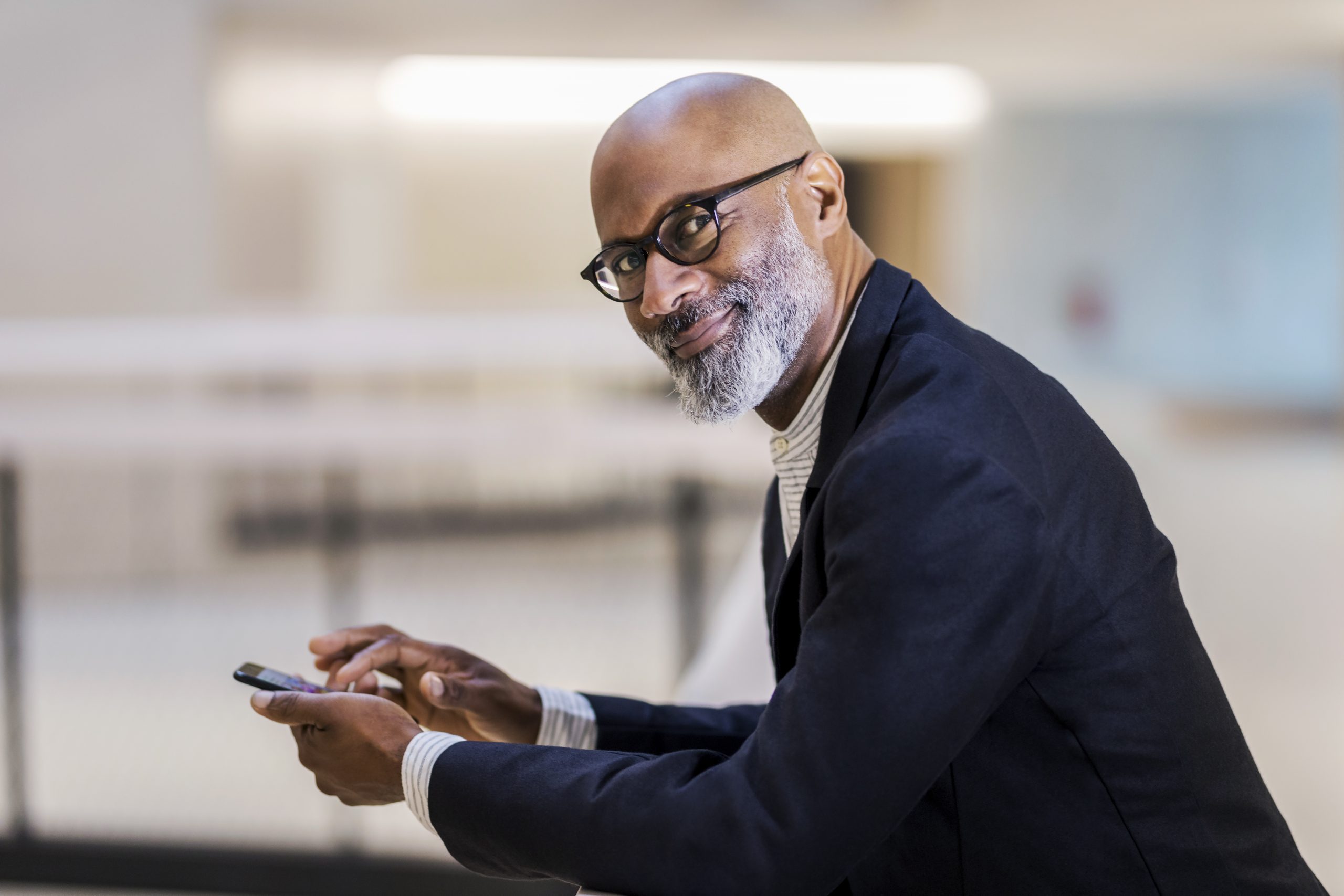portrait-of-smiling-mature-businessman-with-cell-p-2022-03-08-01-20-14-utc-scaled-1