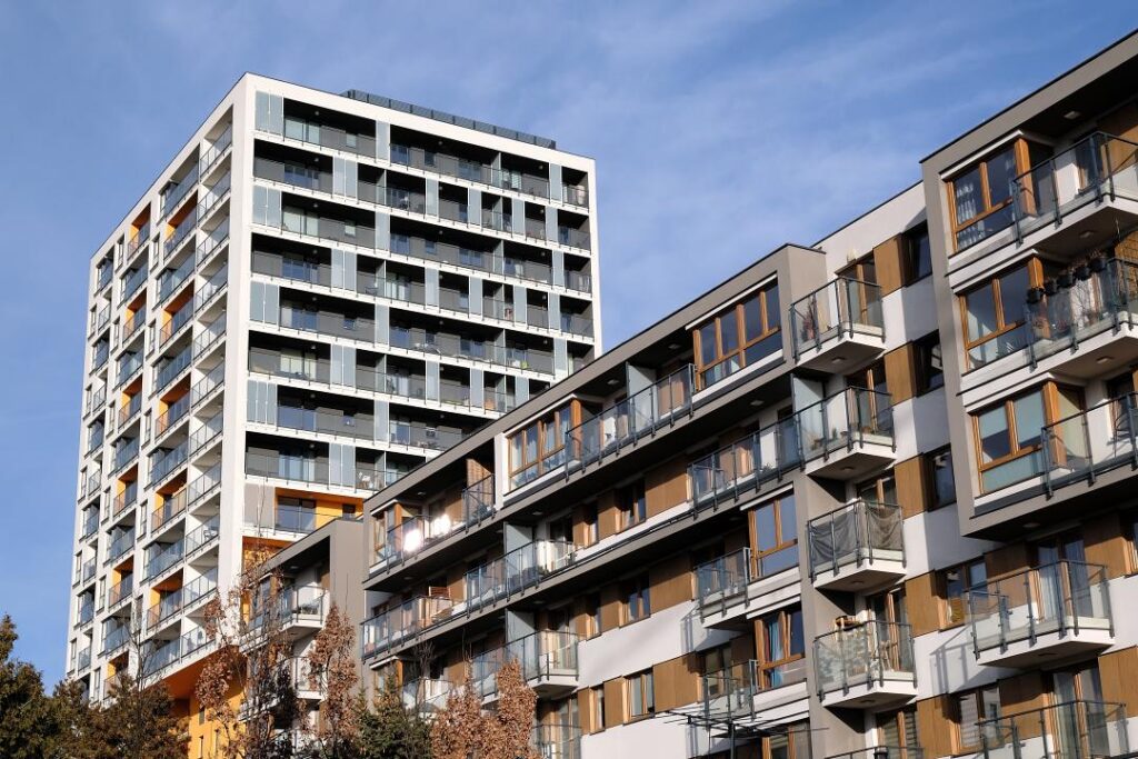 Exteriors of two modern apartment buildings with balcony in cont