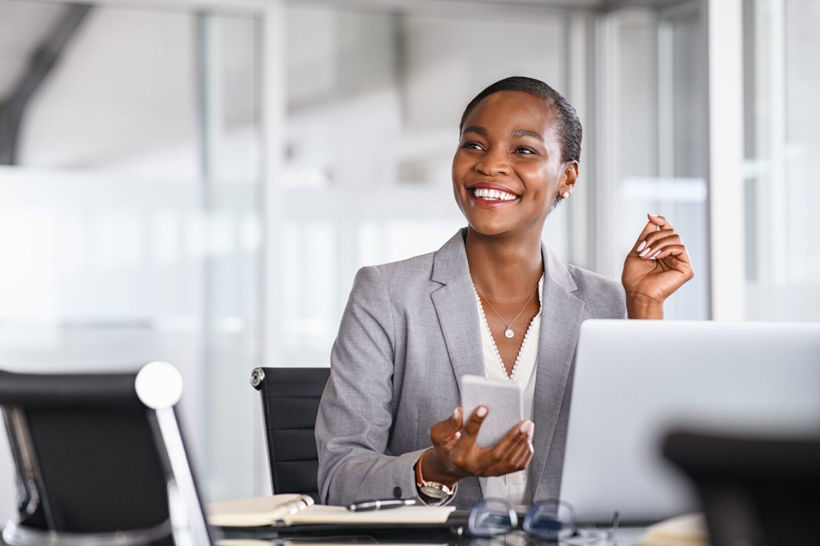 smiling-businesswoman-looking-up-while-working-2022-09-08-19-20-14-utc-scaled-1
