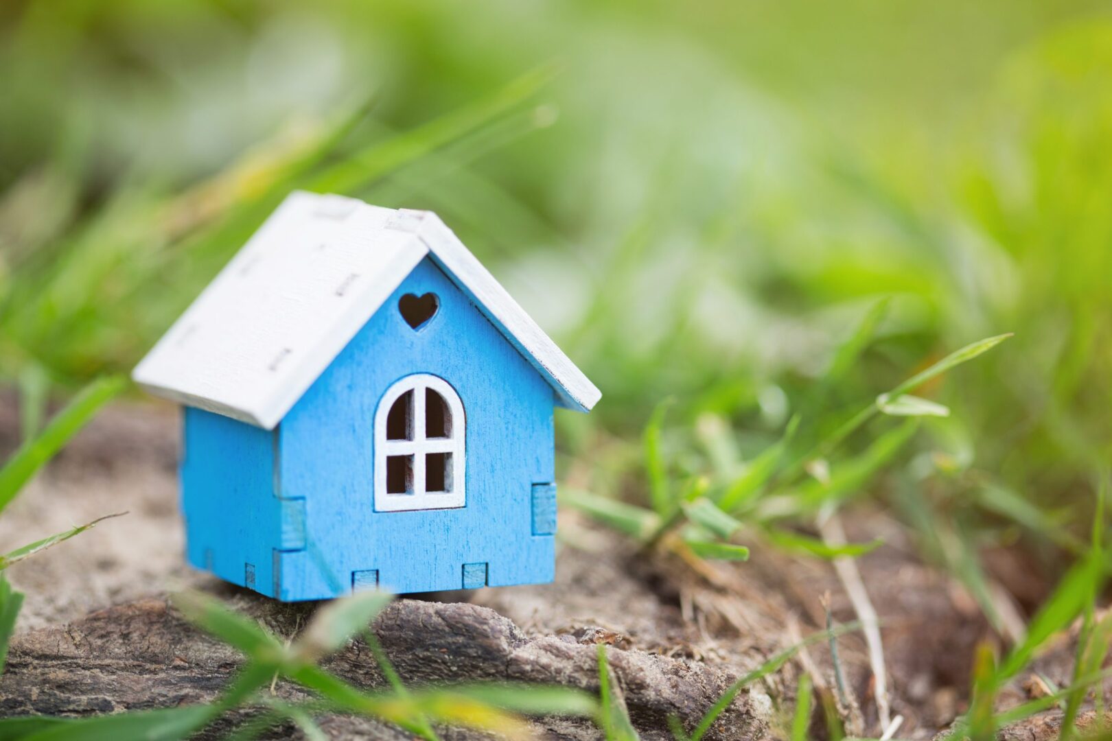 wooden-house-model-close-up-real-estate-business-2021-10-19-14-18-53-utc-scaled-1