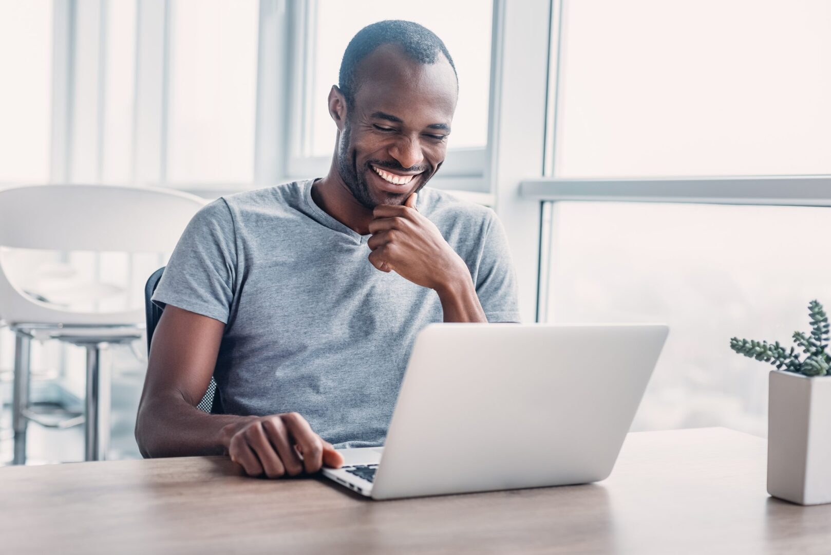 young-businessman-working-on-his-laptop-in-spaciou-2021-12-09-19-34-12-utc-scaled-1
