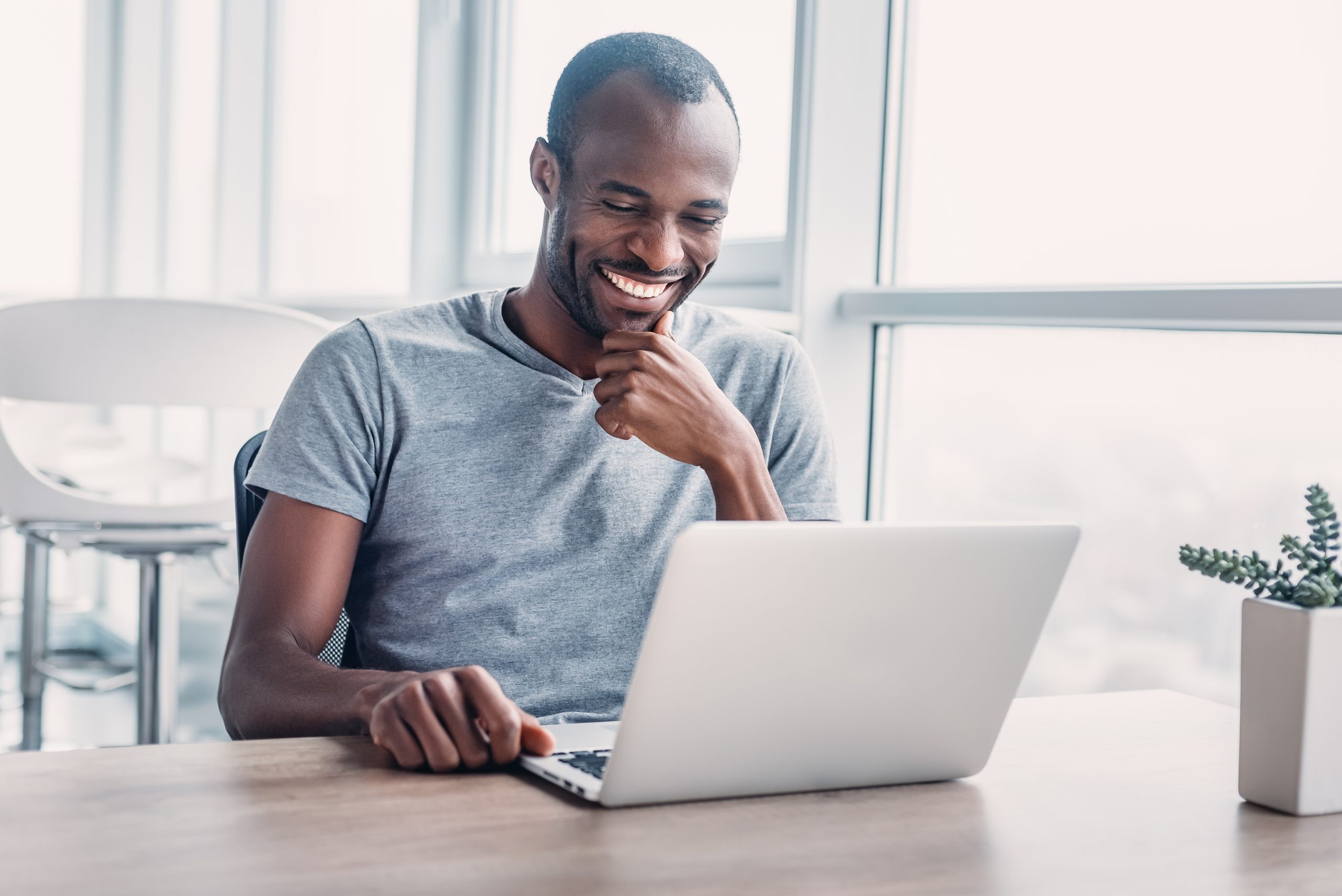 young-businessman-working-on-his-laptop-in-spaciou-2021-12-09-19-34-12-utc-scaled-1